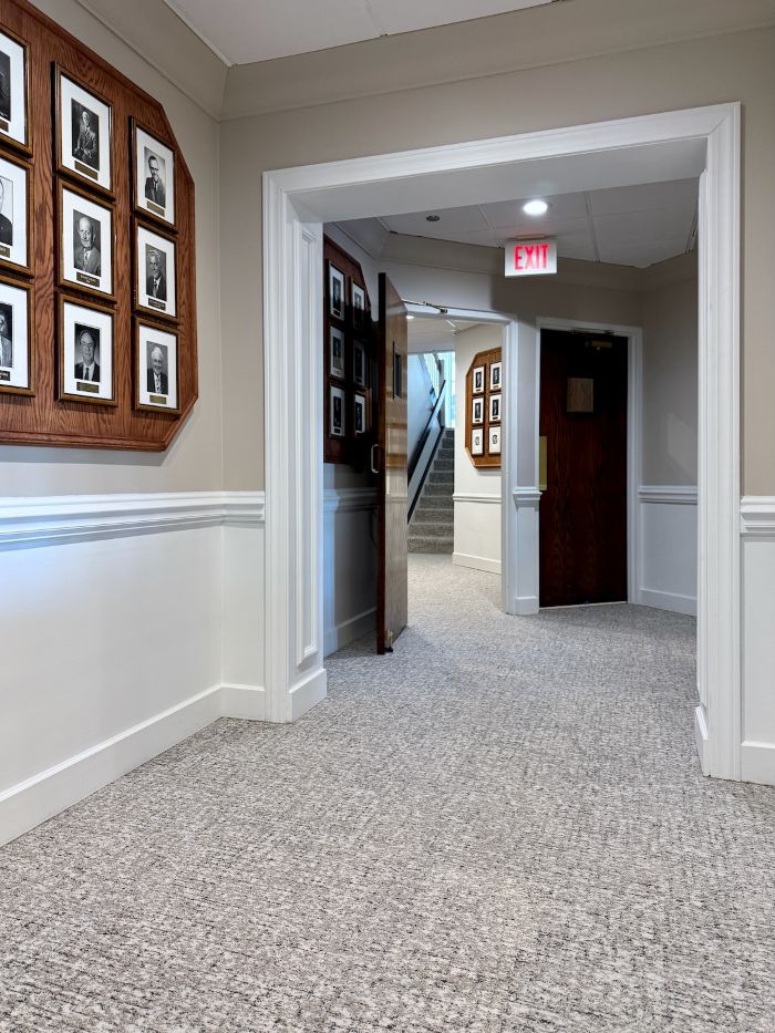 Large commercial space with striped patterned carpet in warm neutral tones